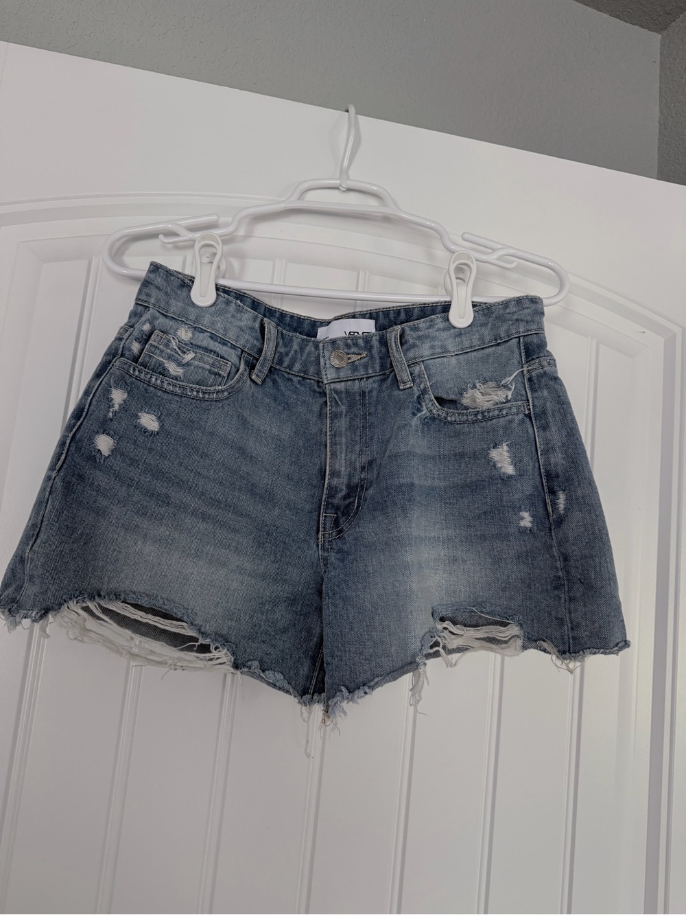 Distressed High-Rise Denim Shorts in Faded Blue - VERVET